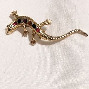 CES Lizard Brooche with multi colored jewels down the back. With clasp closure.
